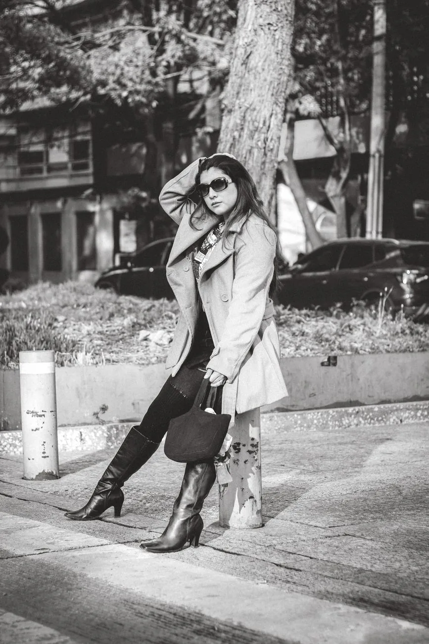 Woman in trench coat on city street